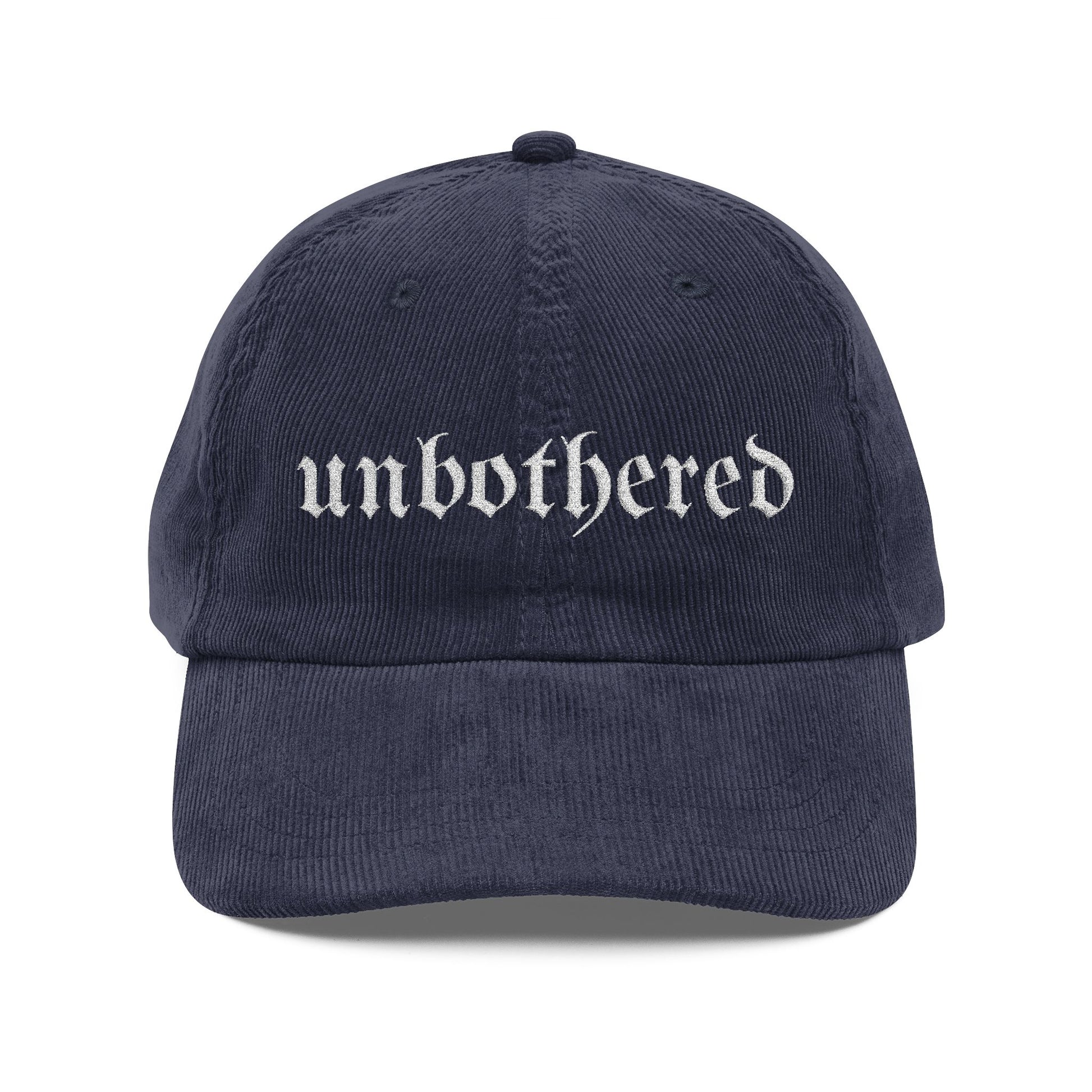 Navy blue cap with 'unbothered' text on a white background