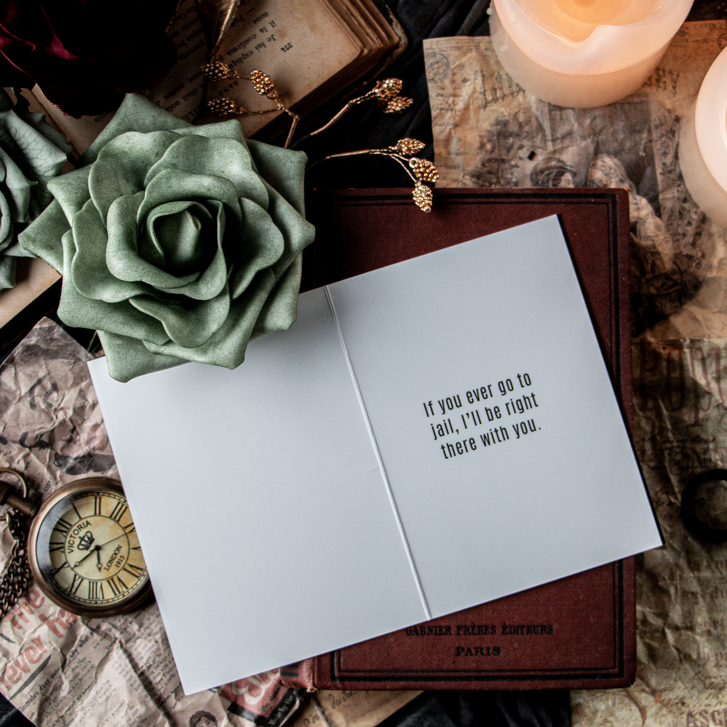 Greeting card with text on an old book with candles and flowers.