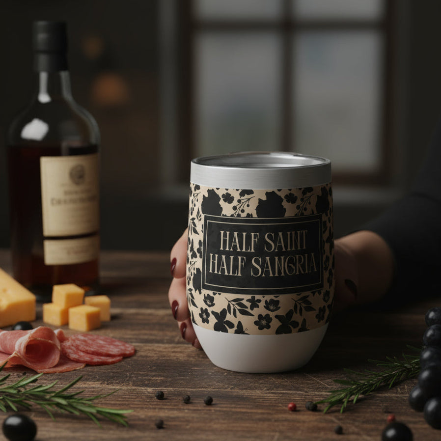 Wine tumbler with decorative sleeve on a wooden table with food items