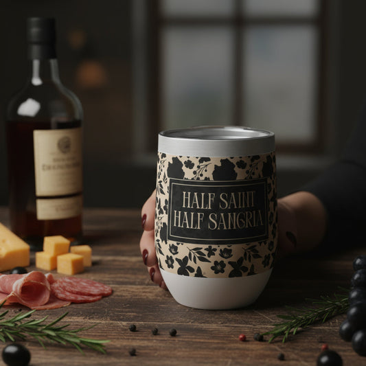 Wine tumbler with decorative sleeve on a wooden table with food items