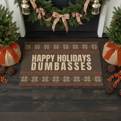 Decorative doormat with 'Happy Holidays Dumbasses' text in a festive setting.