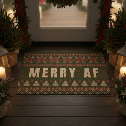 Decorative doormat with 'MERRY AF' text on a wooden porch with Christmas decorations.