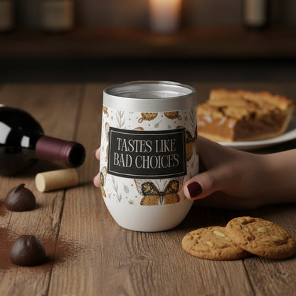 Hand holding a mug with a humorous label on a wooden table with cookies and chocolate.