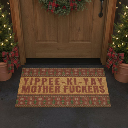 Doormat with offensive text in front of a wooden door decorated for Christmas.