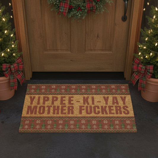 Doormat with offensive text in front of a wooden door decorated for Christmas.